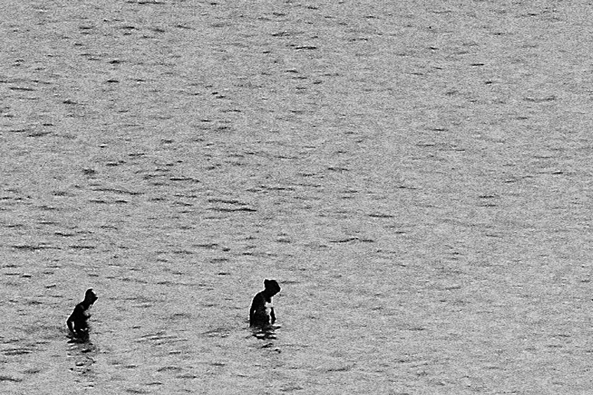 The blurred silhouettes of two women in the sea in Brittany in the summer, from the series Another summer by Emmanuel Pineau