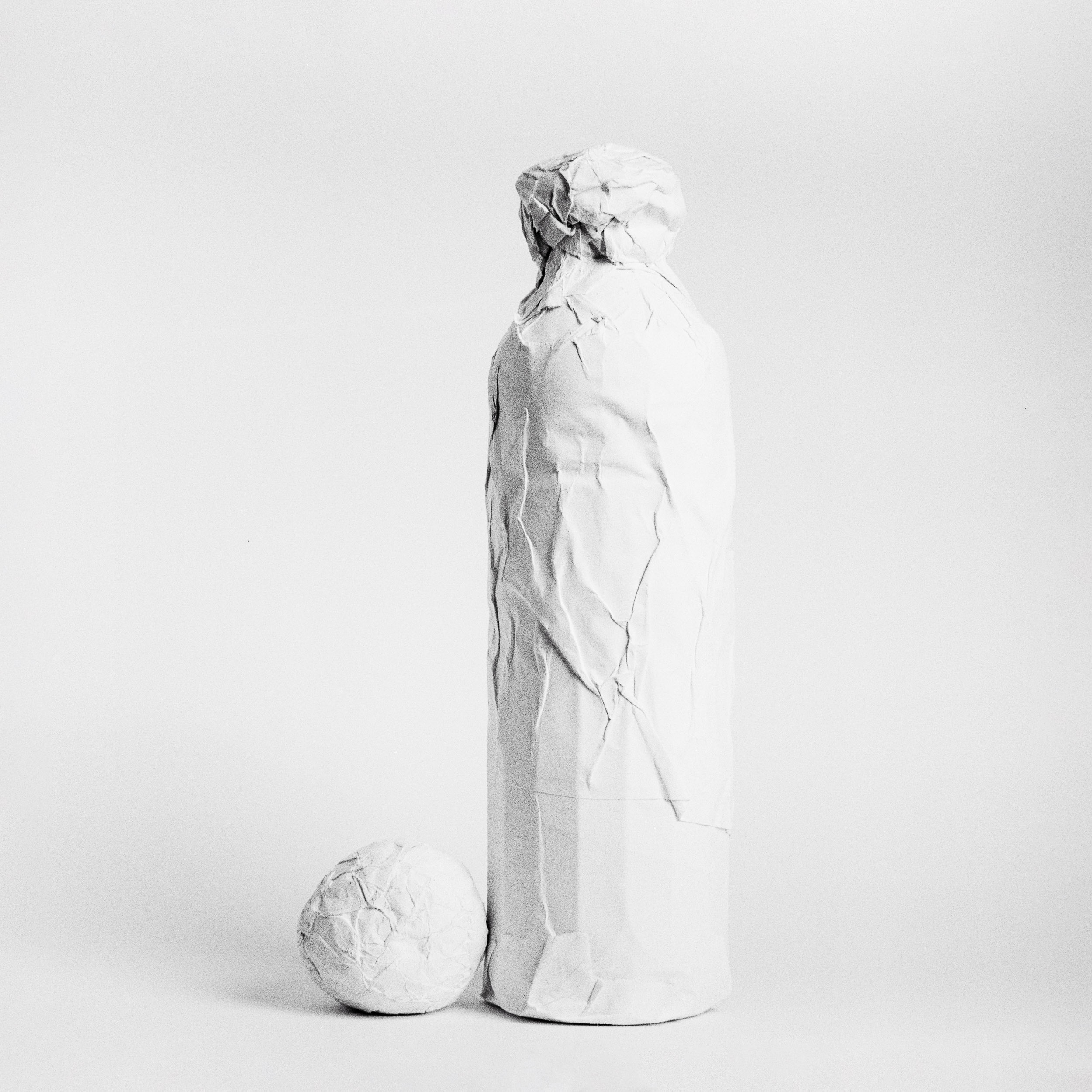 paper wrapped bottle, still life shot on Kentmere 100 by Emmanuel Pineau