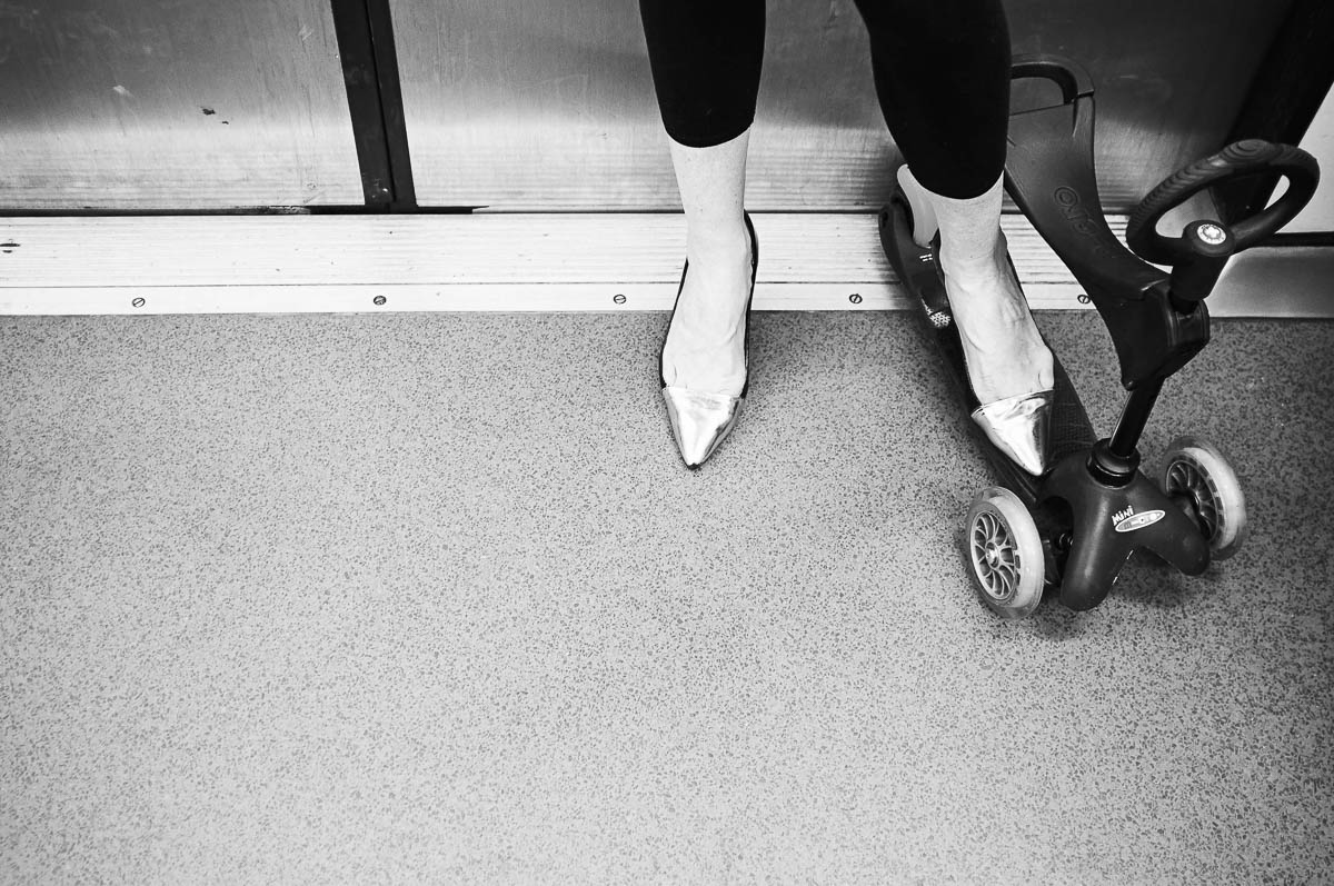 The feet of a woman wearing gold high heels on the Paris metro, from the series Going Underground by Emmanuel Pineau