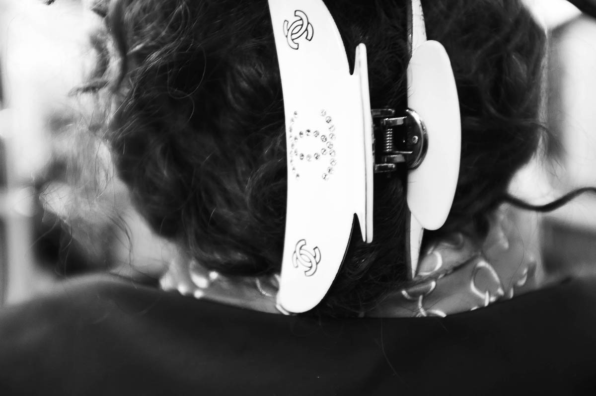 Close-up of a woman's hair seen from behind, wearing a Chanel hair clip, from the series Going Underground by Emmanuel Pineau