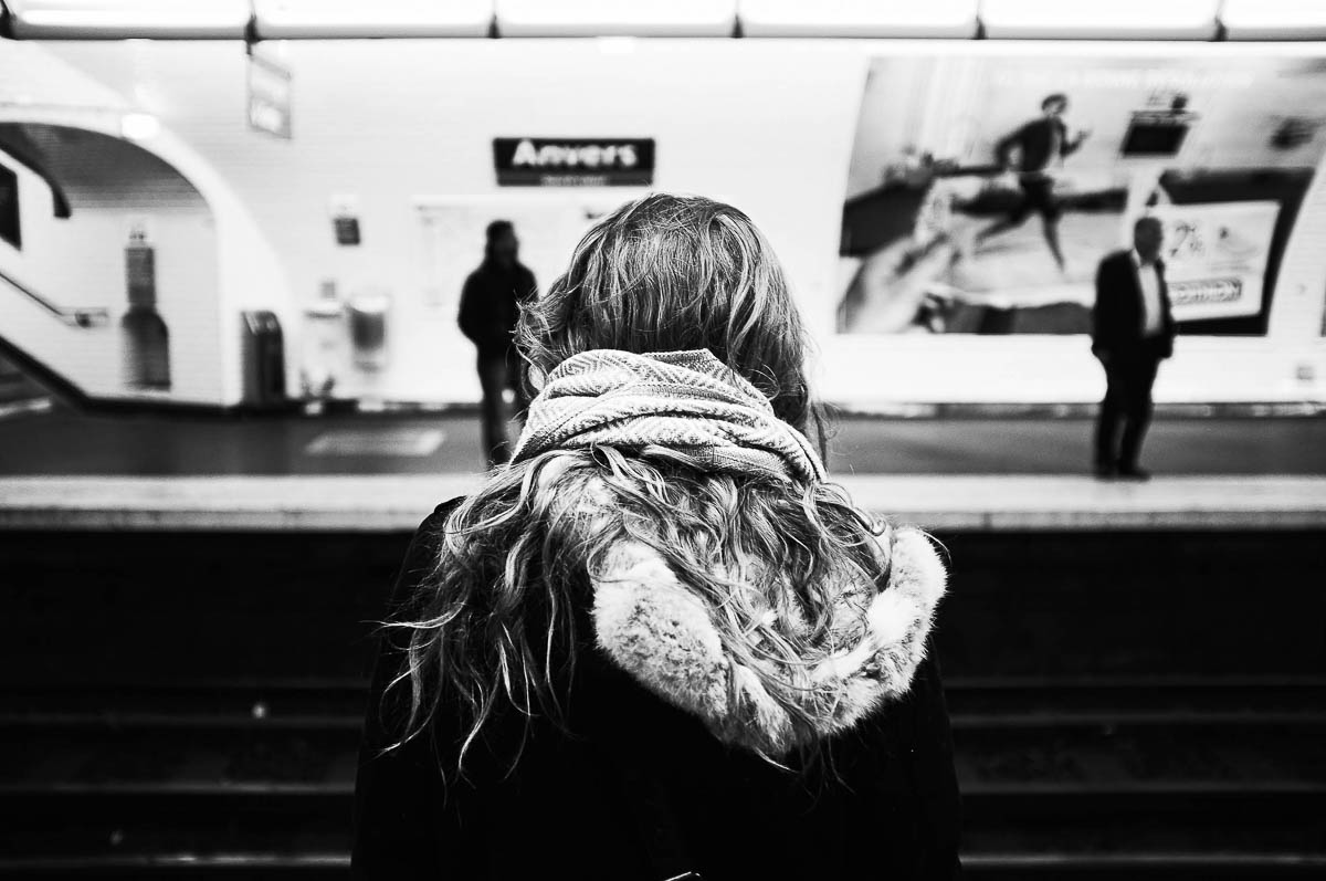 Close-up of the hair of a blonde woman seen from behind, waiting on the platform of the Paris metro, from the series Going Underground by Emmanuel Pineau