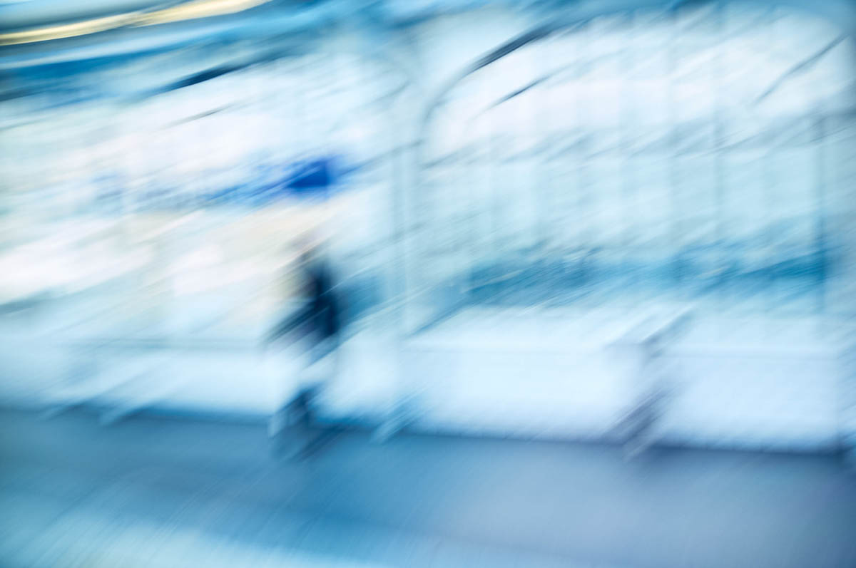 The blurry silhouette of a person waiting on a subway platform in Paris, from the series Going Underground by Emmanuel Pineau