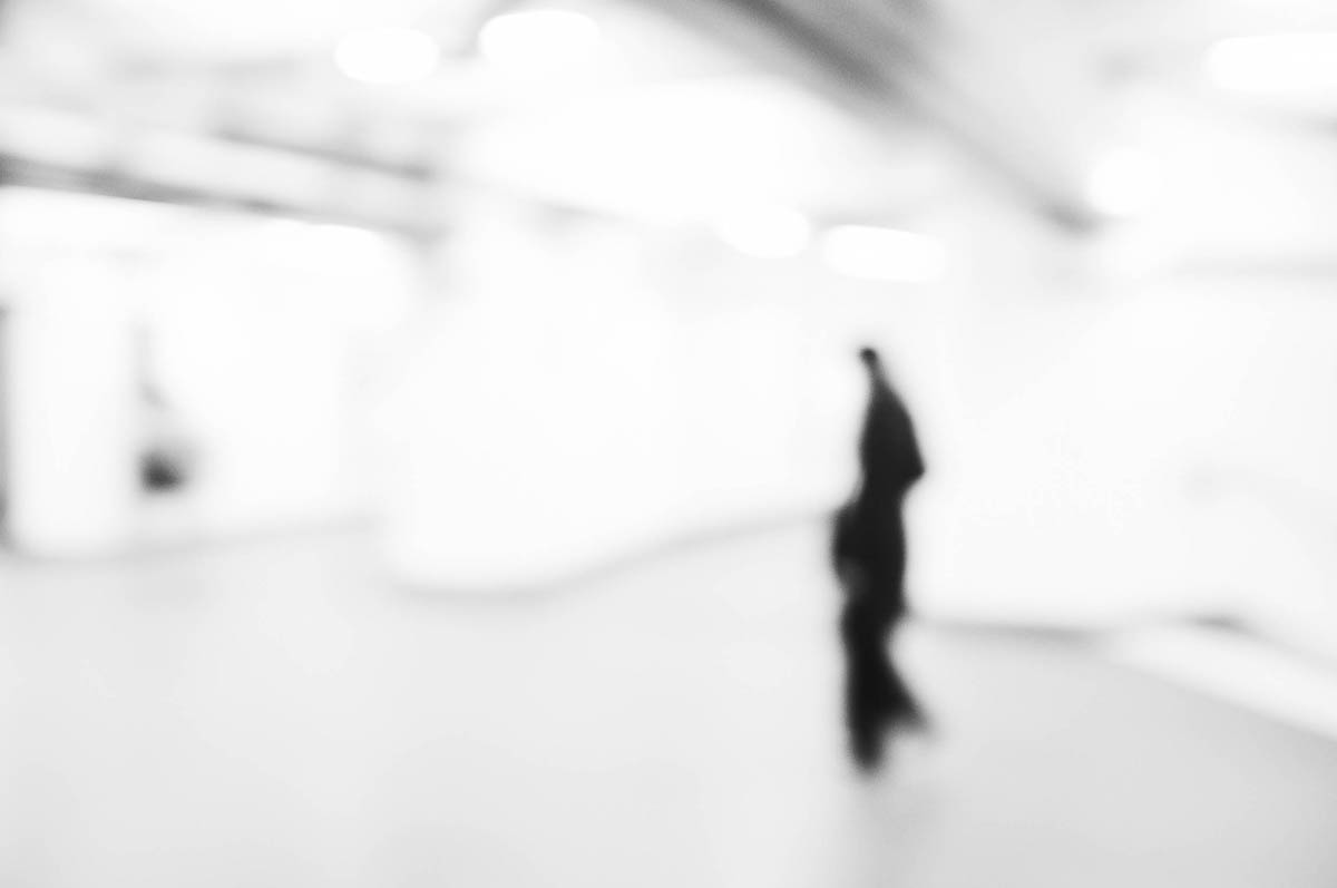 A dark, blurry figure in the corridors of the Paris metro, from the series Going Underground by Emmanuel Pineau