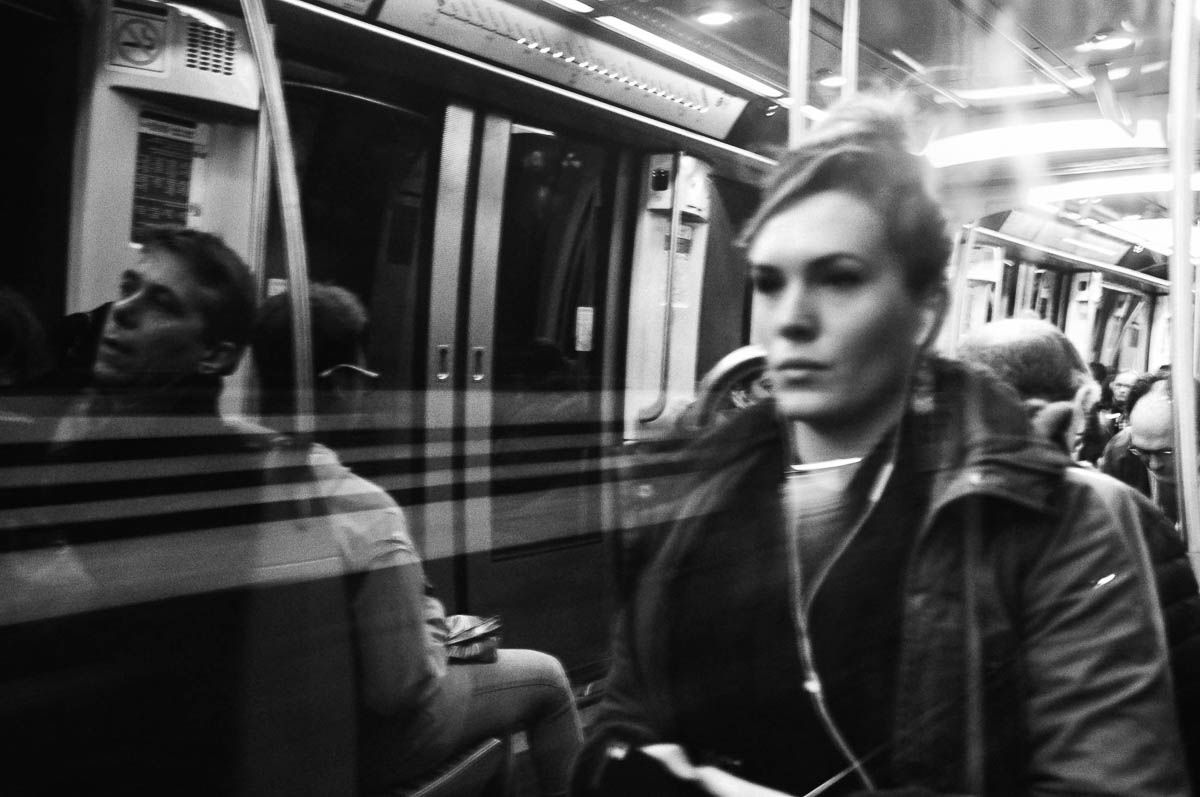 A woman sitting in a subway train in Paris, from the series Going Underground by Emmanuel Pineau