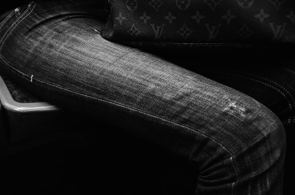 Close-up of the legs of a woman sitting opposite me with a Vuitton bag on the Paris metro, from the series Going Underground by Emmanuel Pineau