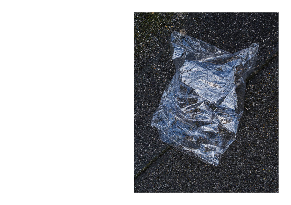 A clear plastic package abandoned on the ground after the market in Montreuil, from the series I will be around by Emmanuel Pineau