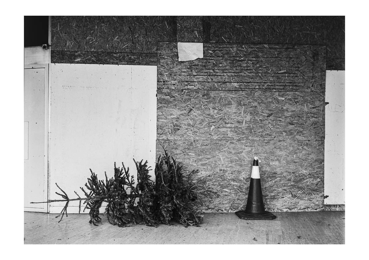 An abandoned Christmas tree next to one of the closed shops in the shopping centre in the centre of Cholet. From the series I will be around by Emmanuel Pineau
