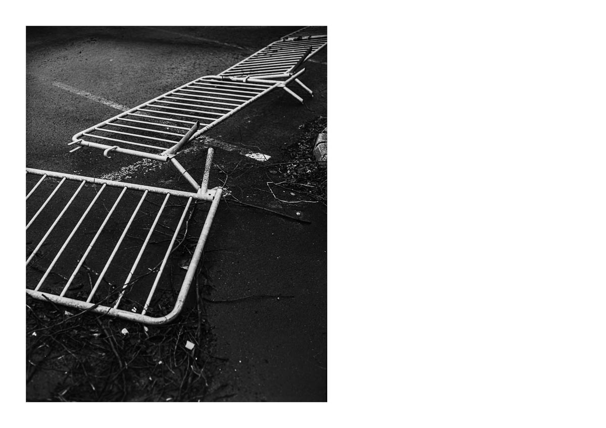 Metal barriers overturned in the streets of Cholet, from the series I will be around by Emmanuel Pineau