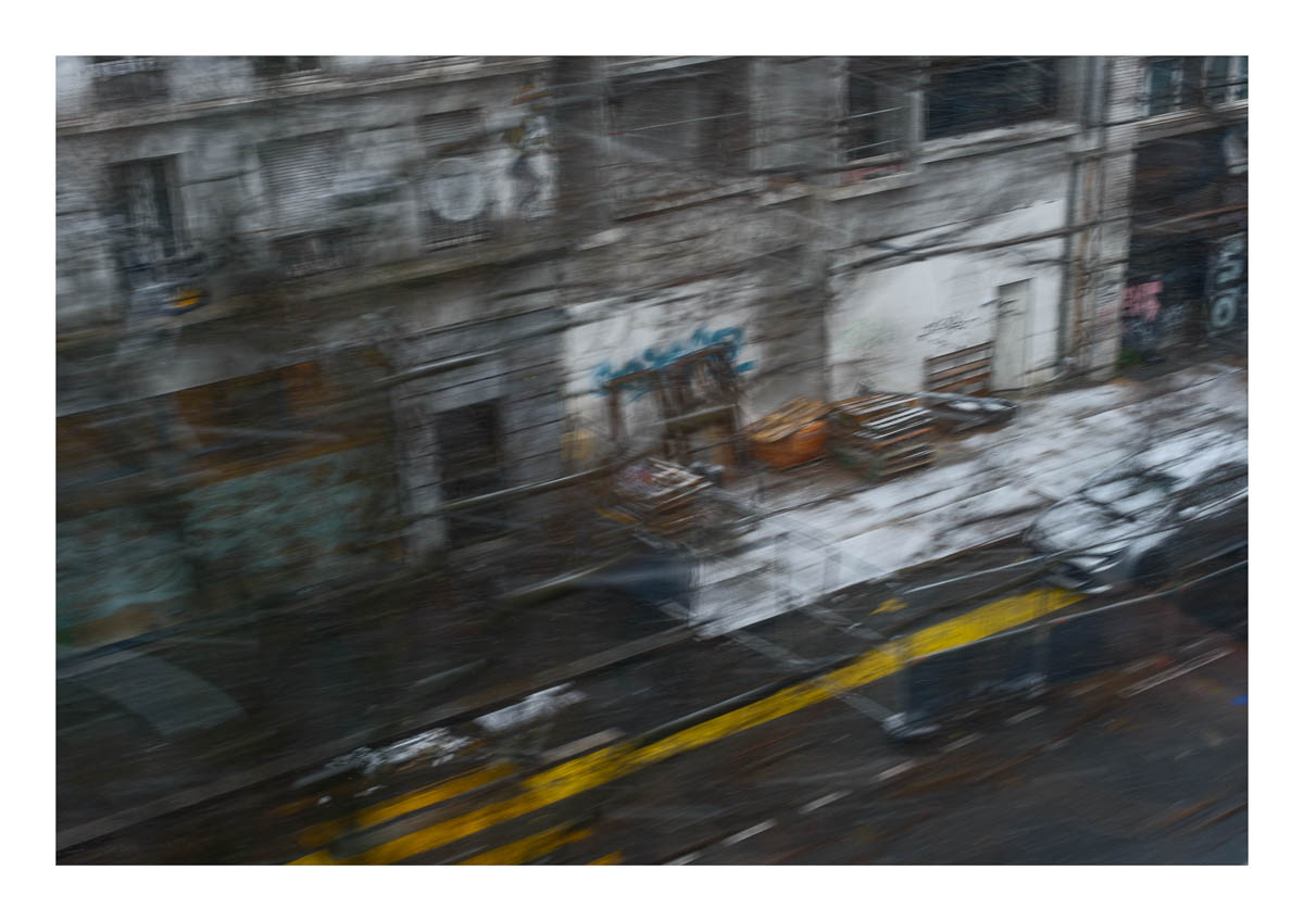 The streets of the 20th arrondissement as seen from the moving elevated metro, from the series I will be around by Emmanuel Pineau