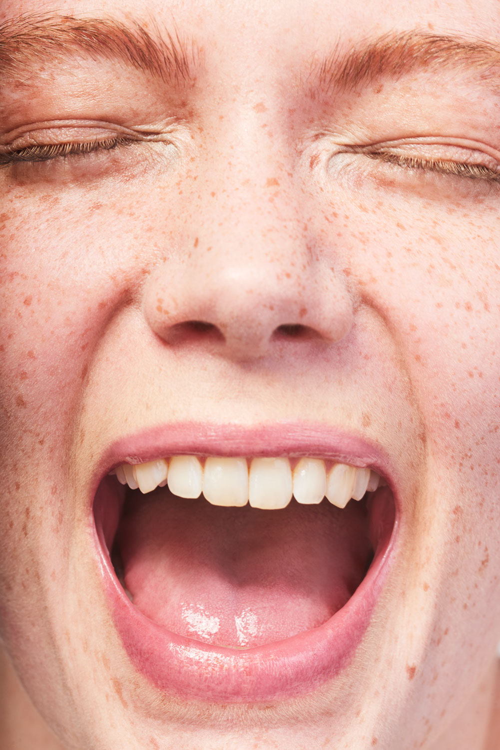 Close up of a Caucasian model's face with freckles by Sophie Delaporte