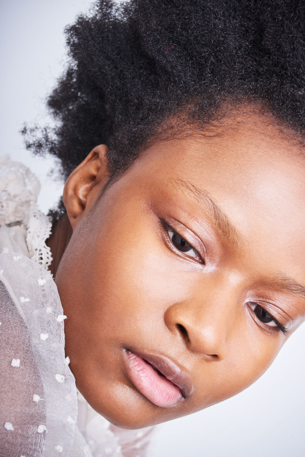 Close up of a model's face with natural skin texture by Sophie Delaporte