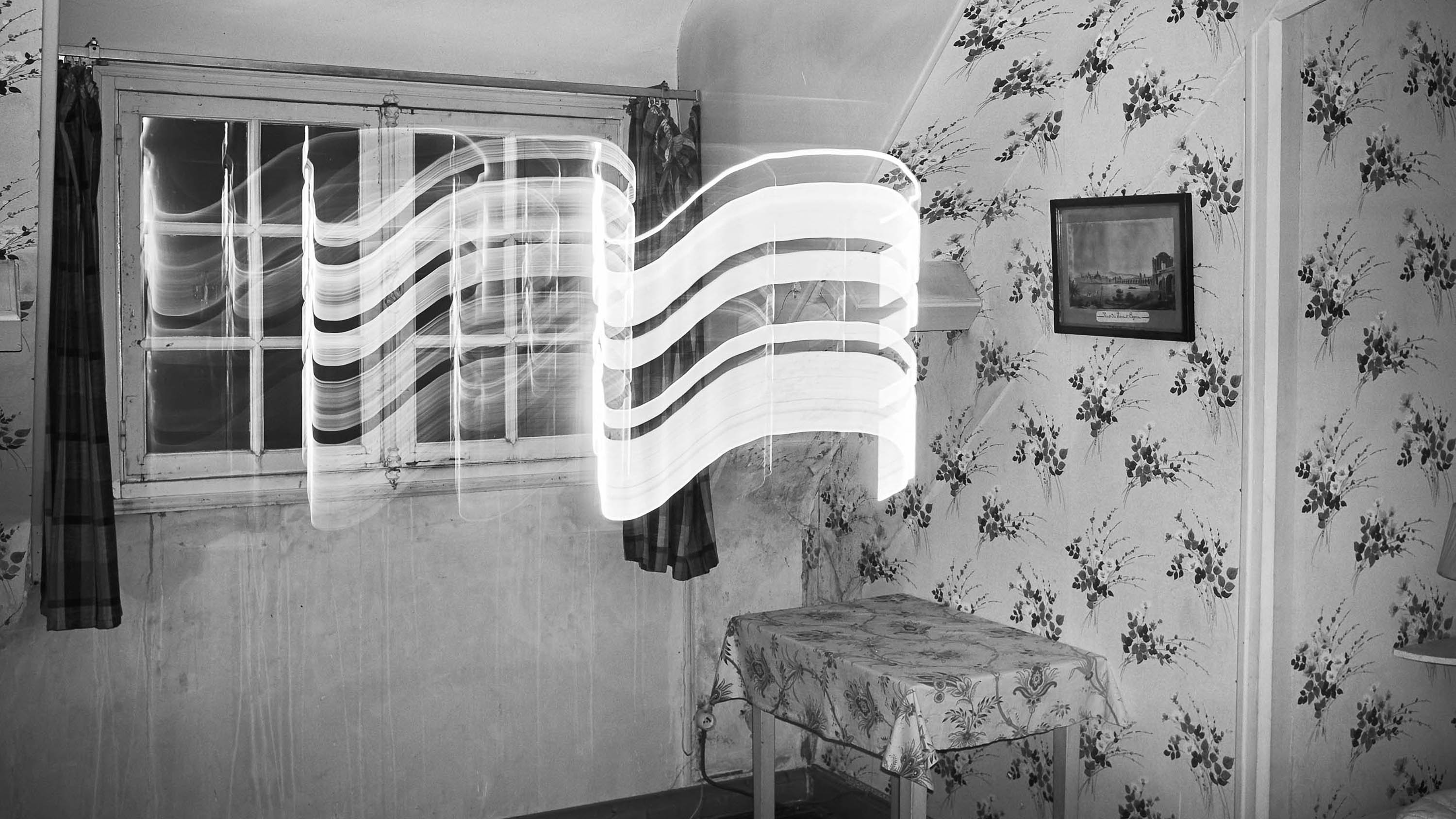 Old fashion bedroom with starnge light effect, black and white photograph, from the series out of disorders, by Emmanuel Pineau
