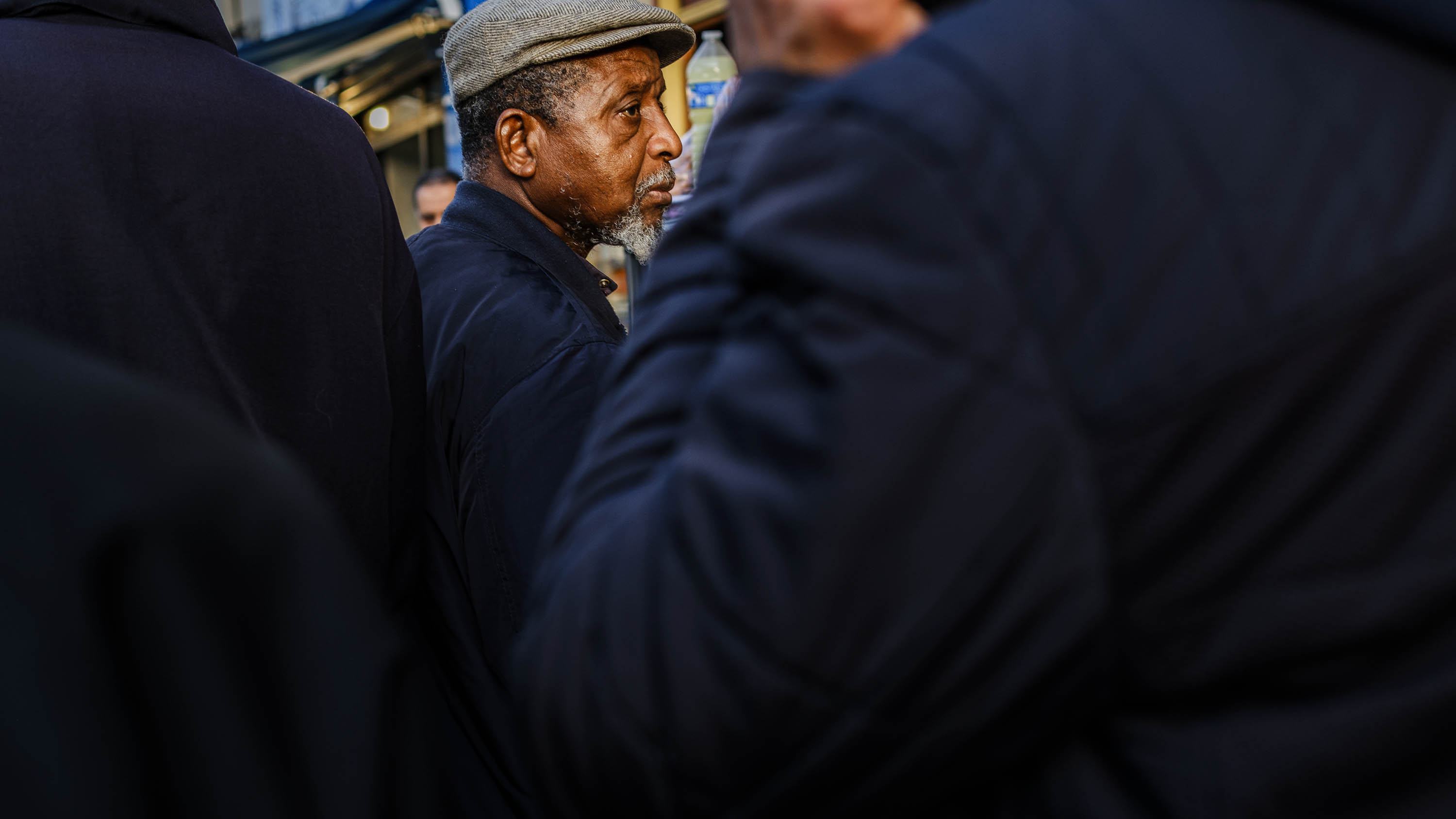 Man in a crowd on a busy steet, from the series I will be around, by Emmanuel Pineau