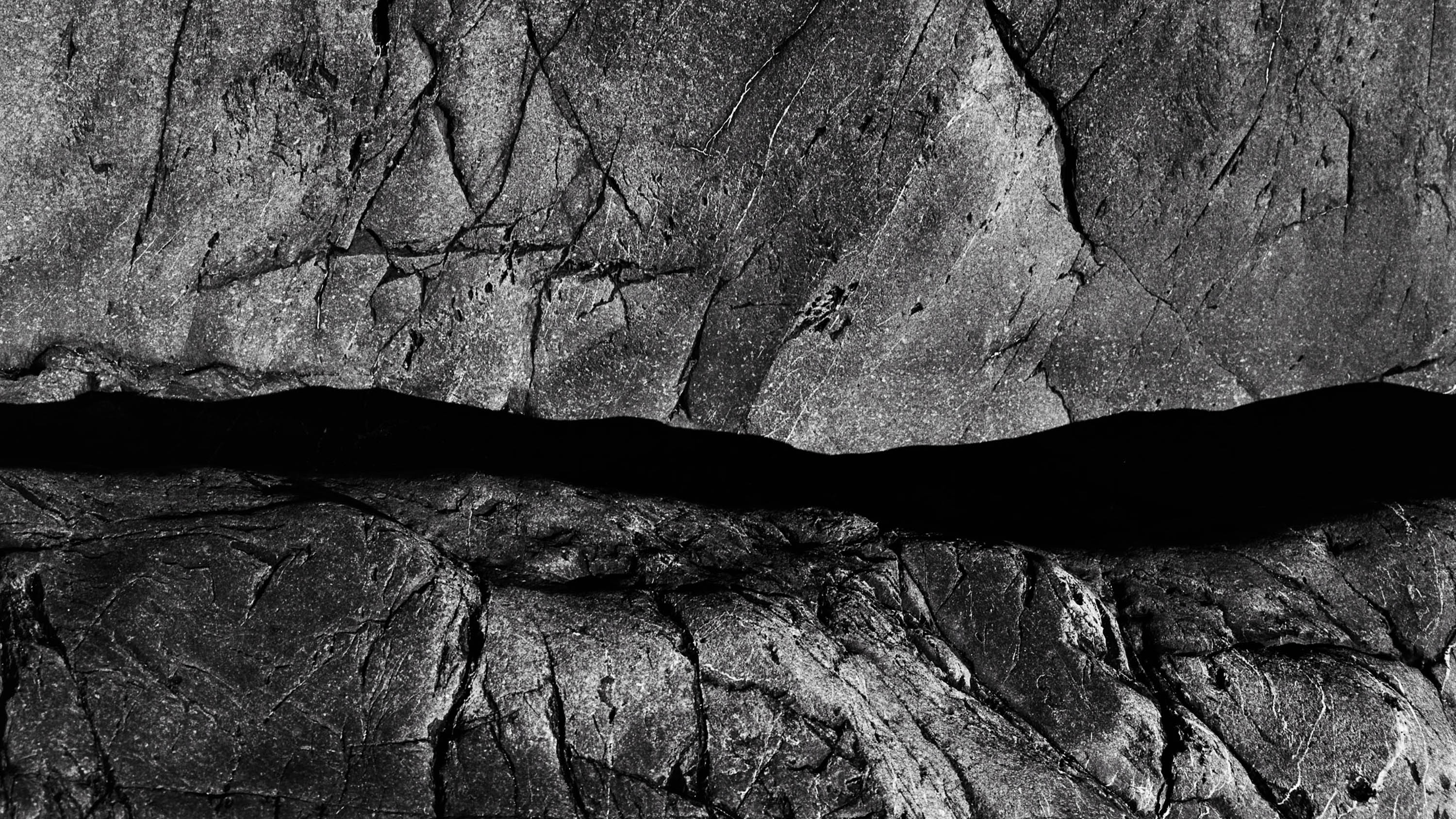 Close-up of a granite rock on a beach in northern Brittany, black and white analog photography from the series Solid as a rock by Emmanuel Pineau