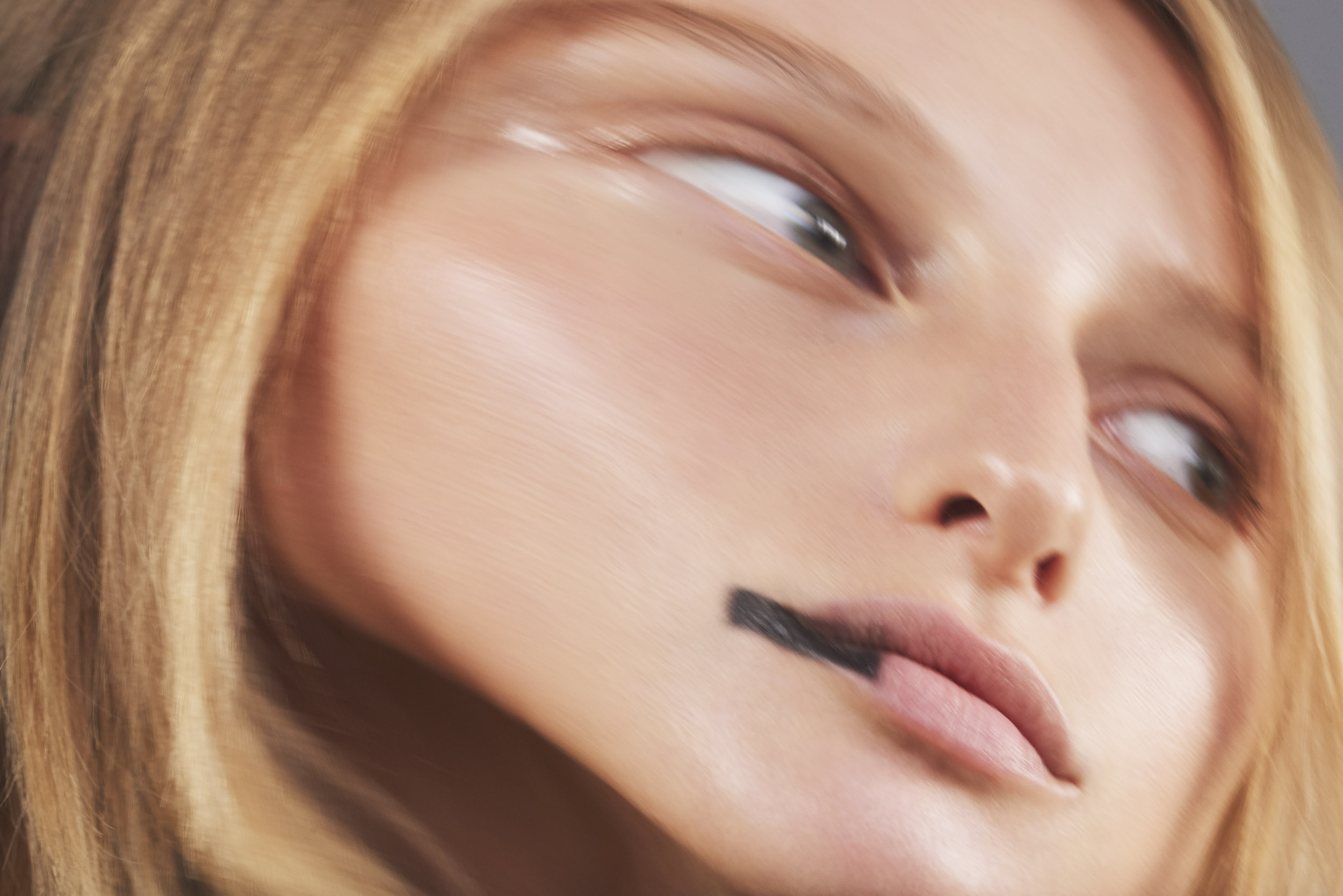 Close up of a blond model's face, photography by Sophie Delaporte