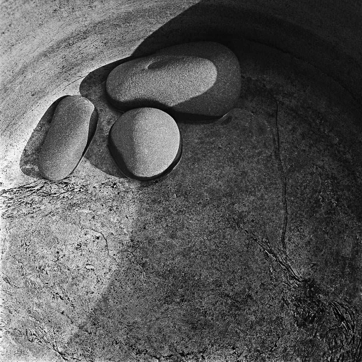Three granite pebbles at the bottom of an old aluminum saucepan, from the series One piece of my mind by Emmanuel Pineau