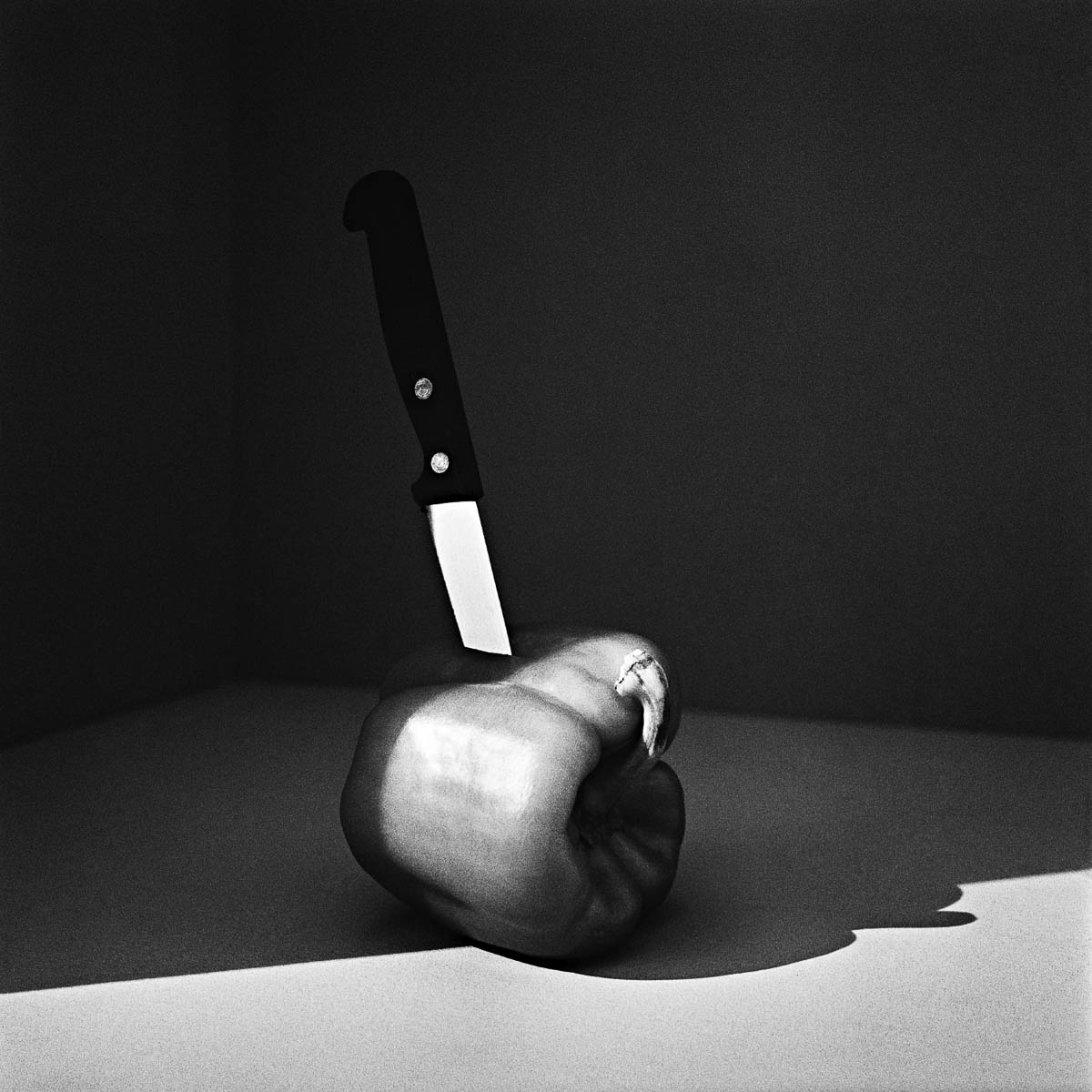 Still life, kitchen knife stuck in a bell pepper, from the series One piece of my mind by Emmanuel Pineau