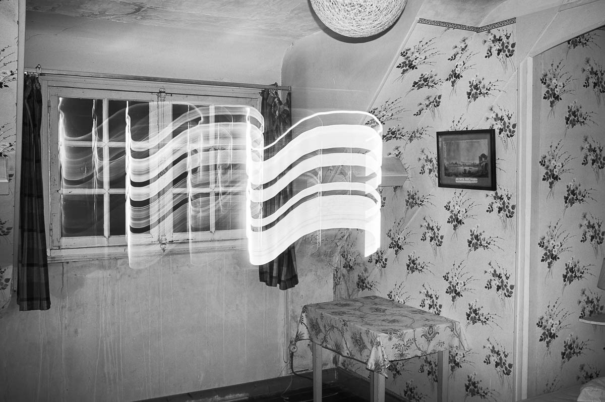Old fashion bedroom with starnge light effect, black and white photograph, from the series out of disorders, by Emmanuel Pineau, from the series Out of disorders by Emmanuel Pineau